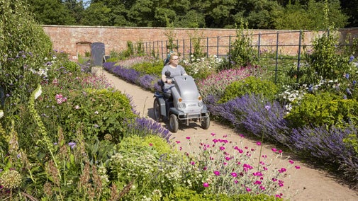 Visitor on buggy exploring the walled garden at Attingham Park, Shropshire